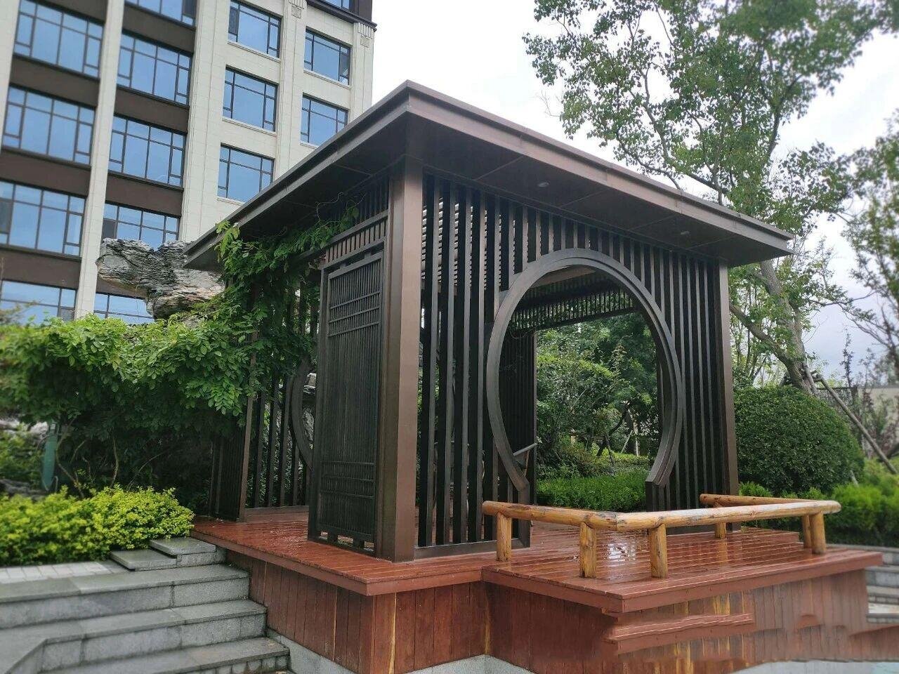 Satin finish stainless steel sheets in a refined bronze PVD color, applied to a modern outdoor architectural pavilion to provide superior weather resistance and a sophisticated matte look.