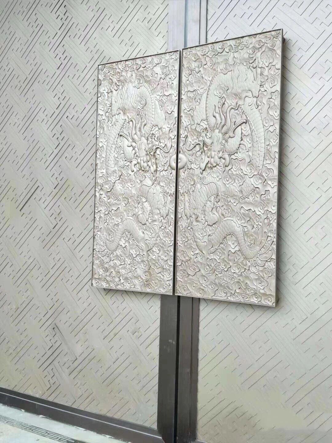 A highly detailed, artistic door featuring liver cast metal relief panels depicting intricate Chinese dragons and clouds
