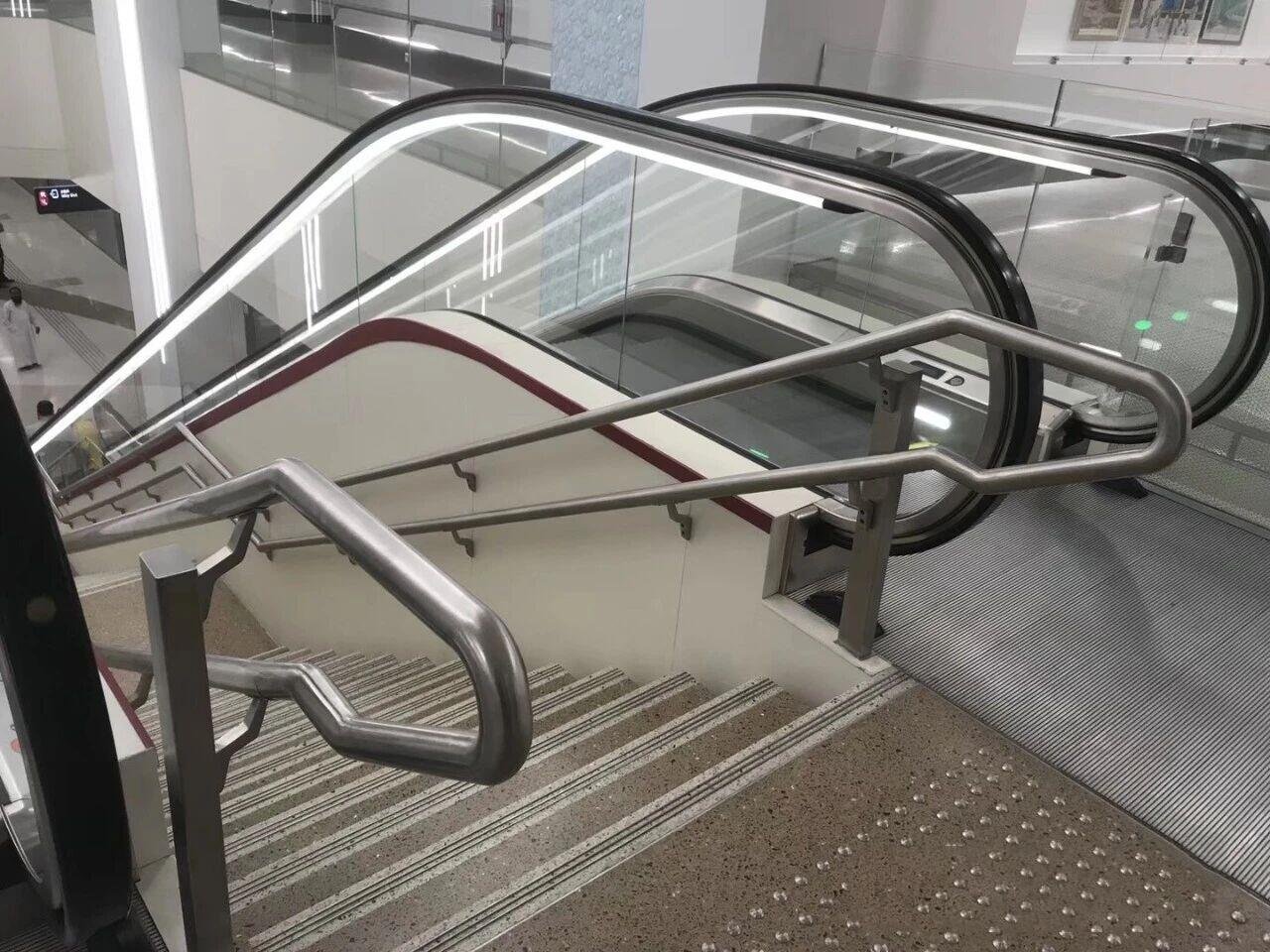 Wall-Mounted Handrail and guardrail system made of Grade 304 stainless steel for a public transit station escalator.