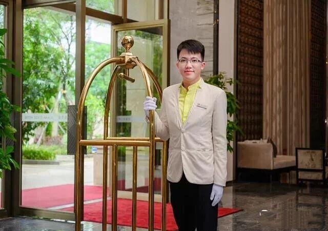 Traditional PVD gold hotel bellman cart with an arched top, featured in our Bespoke Luggage Racks & Carts collection to represent premium Custom Stainless Steel Hotel Furniture and PVD Hospitality Metalwork.