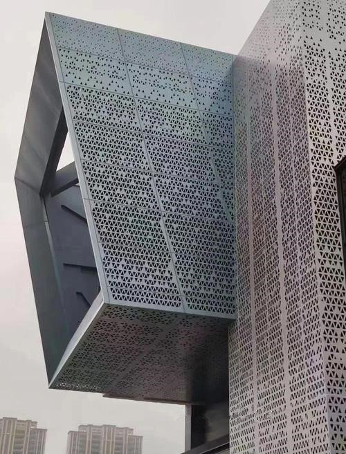 Sophisticated building exterior with triangular perforated architectural aluminium cladding and a fluorocarbon finish.