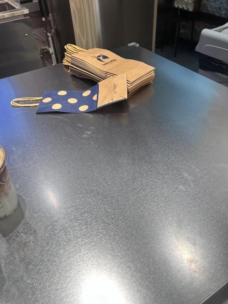 Vibration finish stainless steel commercial work surface or countertop, ideal for hiding fingerprints and scratches in high-traffic retail spaces.