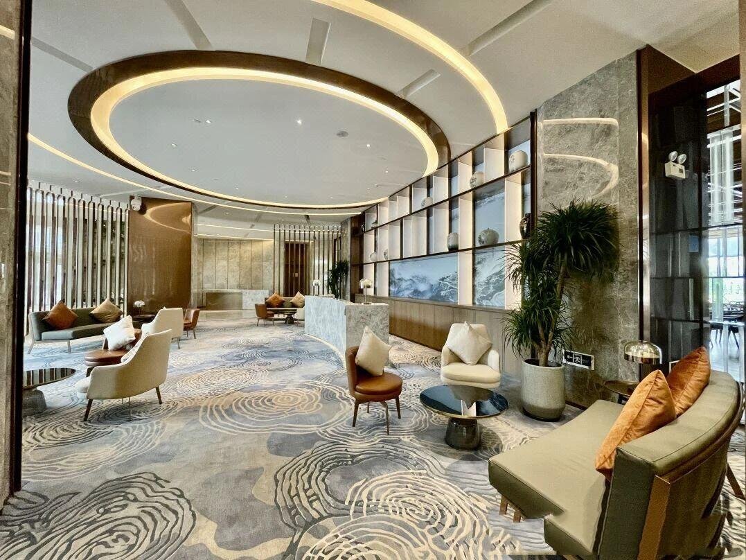 white-swan-hotel-lobby-lounge-curved-bronze-metal-screens-interior