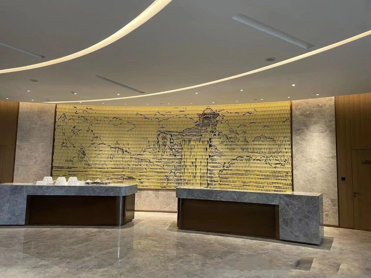 white-swan-hotel-reception-desk-custom-gold-metal-art-wall-facade