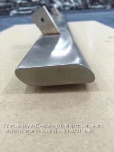 Detailed view of a custom-fabricated stainless steel handrail profile, highlighting the craftsmanship of XYC METALWORKS.