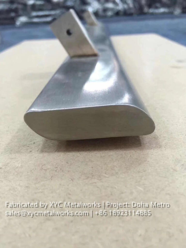 Detailed view of a custom-fabricated stainless steel handrail profile, highlighting the craftsmanship of XYC METALWORKS.
