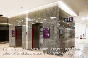 Intricate patterned stainless steel cladding for elevator shafts at Doha Metro, custom-designed by XYC METALWORKS.