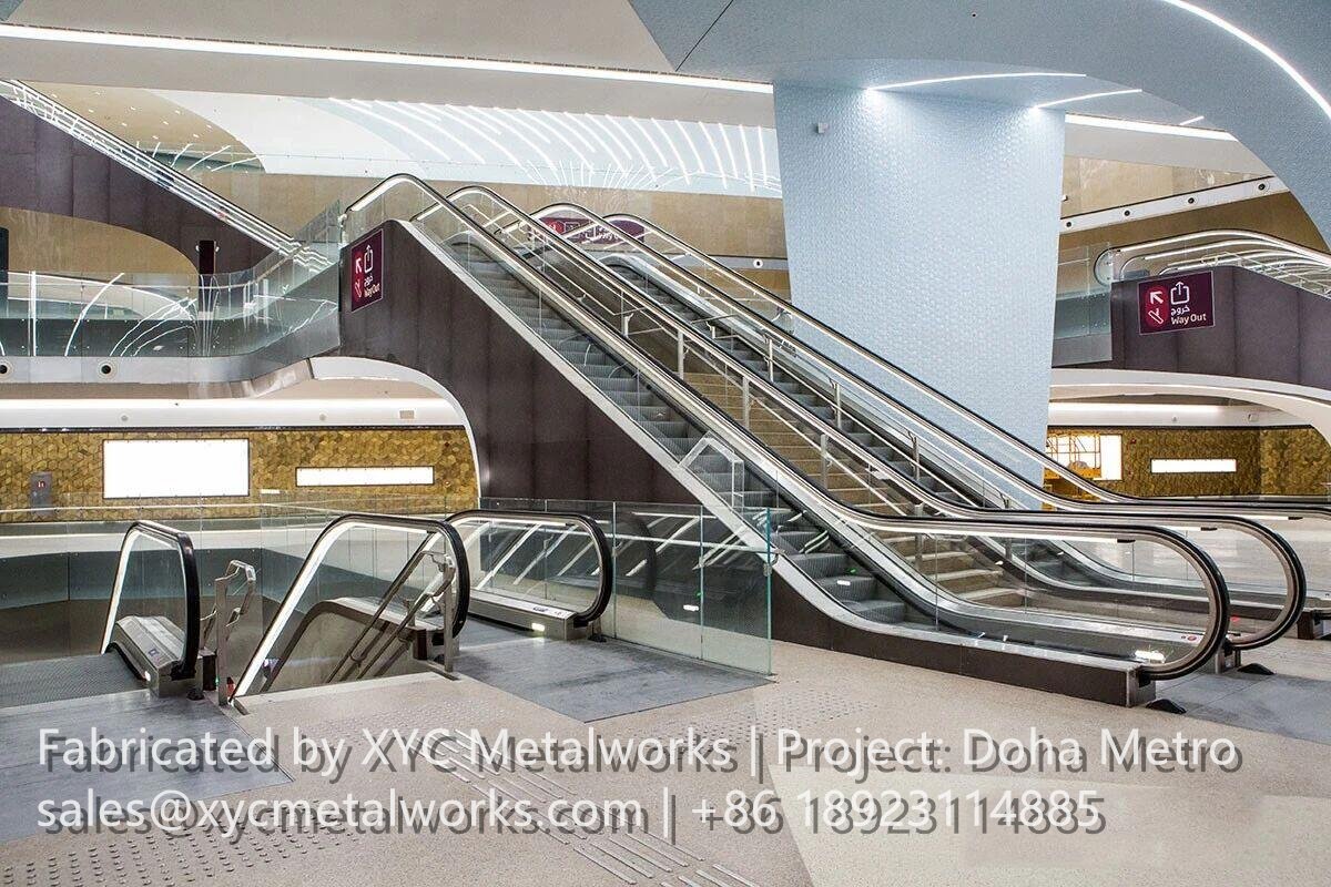 Wide view of the Doha Metro concourse featuring integrated metal balustrades and architectural finishes by XYC METALWORKS.