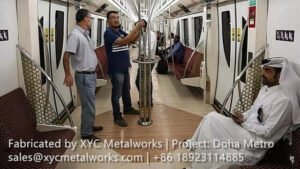 Stainless steel grab poles and handrails inside Doha Metro trains, manufactured for durability and safety by XYC METALWORKS.