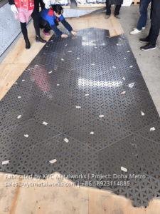 Factory floor layout and quality check of large-scale perforated metal panels for the Doha Metro project.