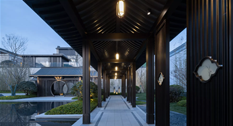 Perspective view of a modern Chinese covered walkway with dark metal pillars, slatted ceiling, and traditional lantern lighting.