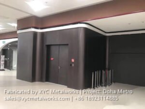 Professional installation of curved metal wall panels and entryways by XYC Metalworks, showcasing a seamless architectural finish.