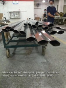 A stack of custom-fabricated hexagonal stainless steel tubes at the XYC Metalworks factory, ready for export to the Doha Metro project.