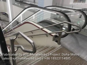 Finished stainless steel handrails and architectural accents by XYC Metalworks integrated into the modern escalator and staircase design of Doha Metro.